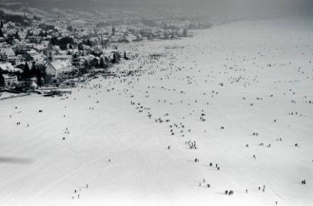Veduta aerea della superficie ghiacciata ricoperta da neve con alcune persone.